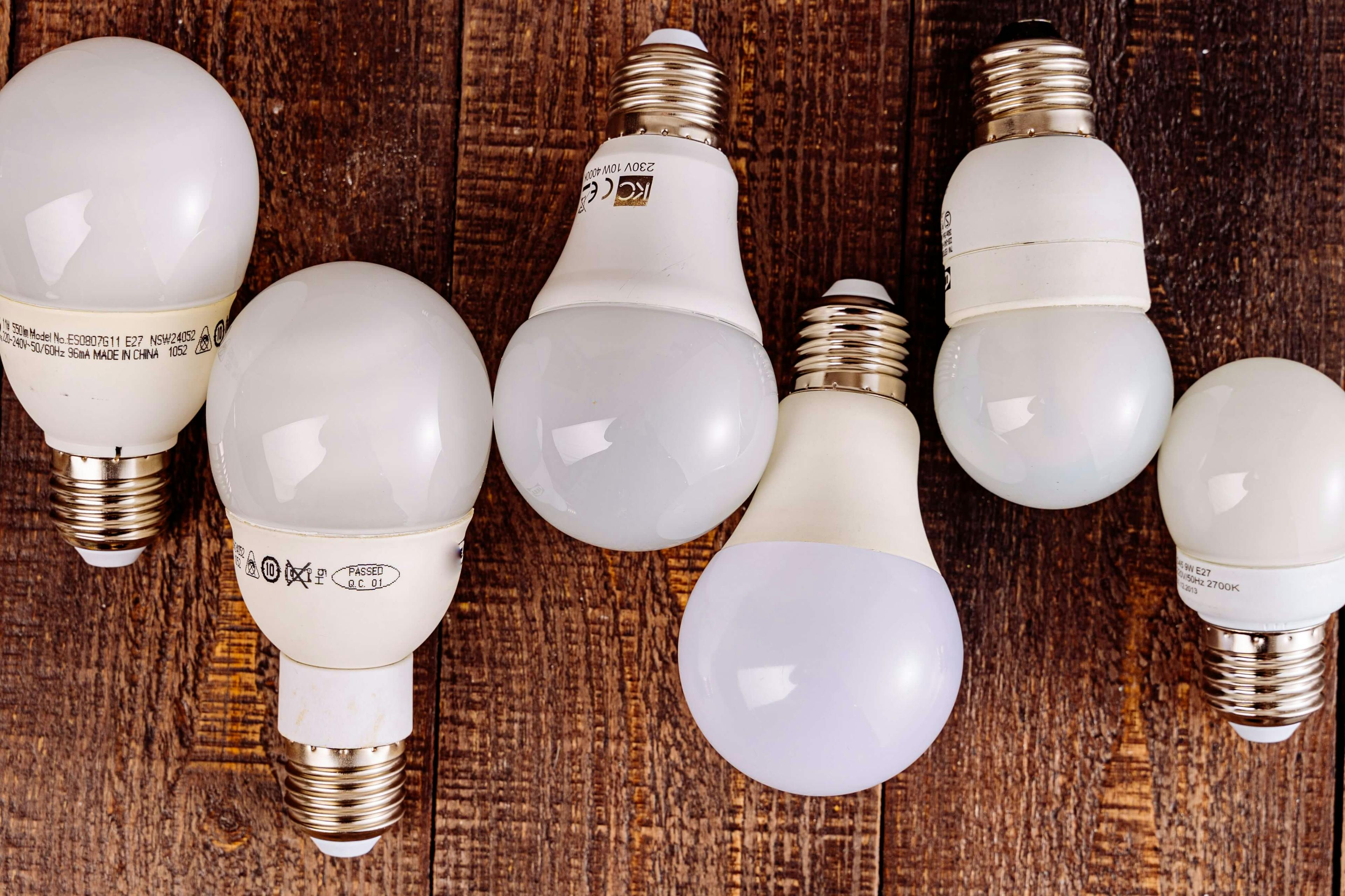 Five light bulbs on a wooden table, as an example of inelastic price elasticity.